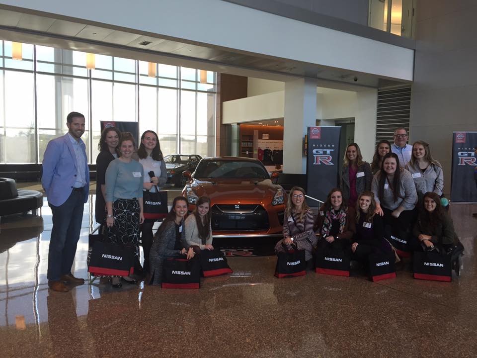 Students in front of sports car