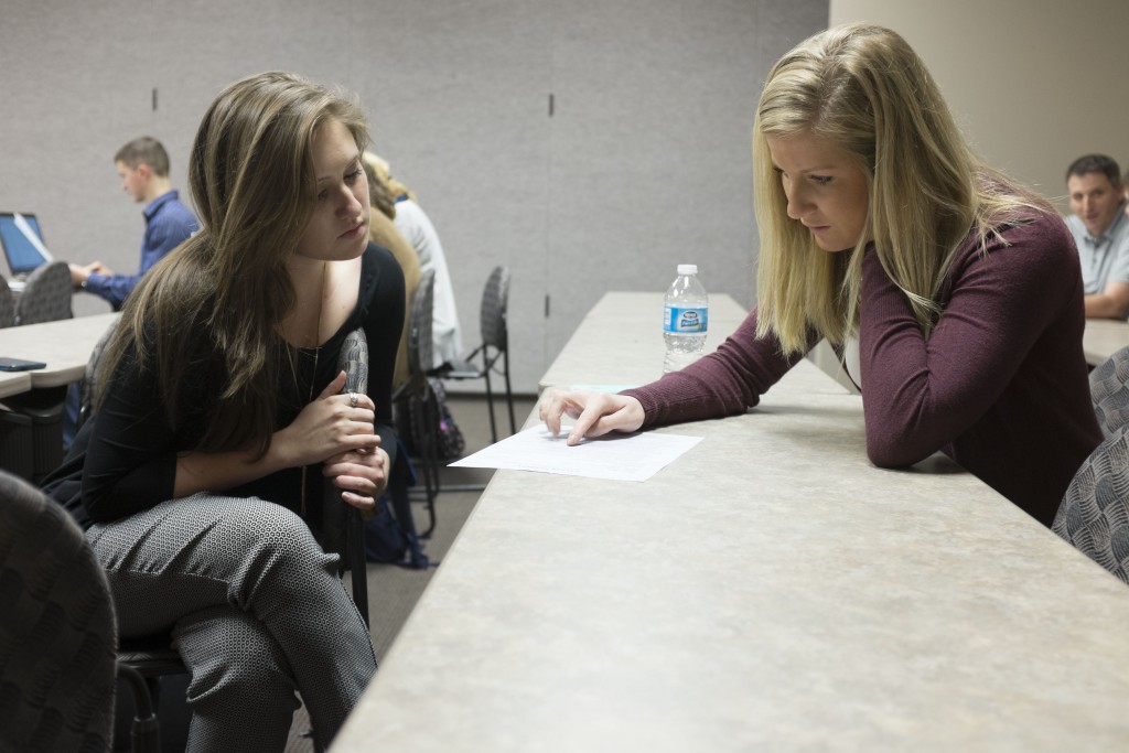 Tabitha Haney Davis ('15) works with a student during a resume building session March 13.