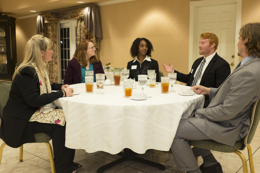 Assistant Professor of Marketing Lori Sloan visits with students at her annual etiquette dinner April 11.