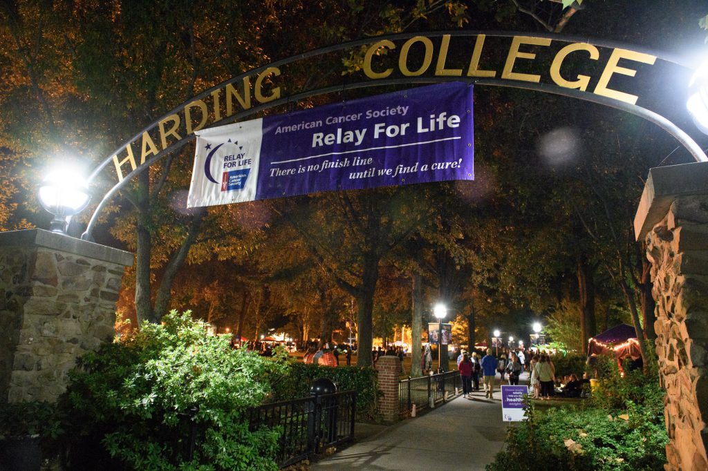 Relay for Life banner handing from Harding arch at night.