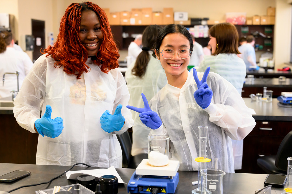 Two pharmacy camp students pose with their equipment 