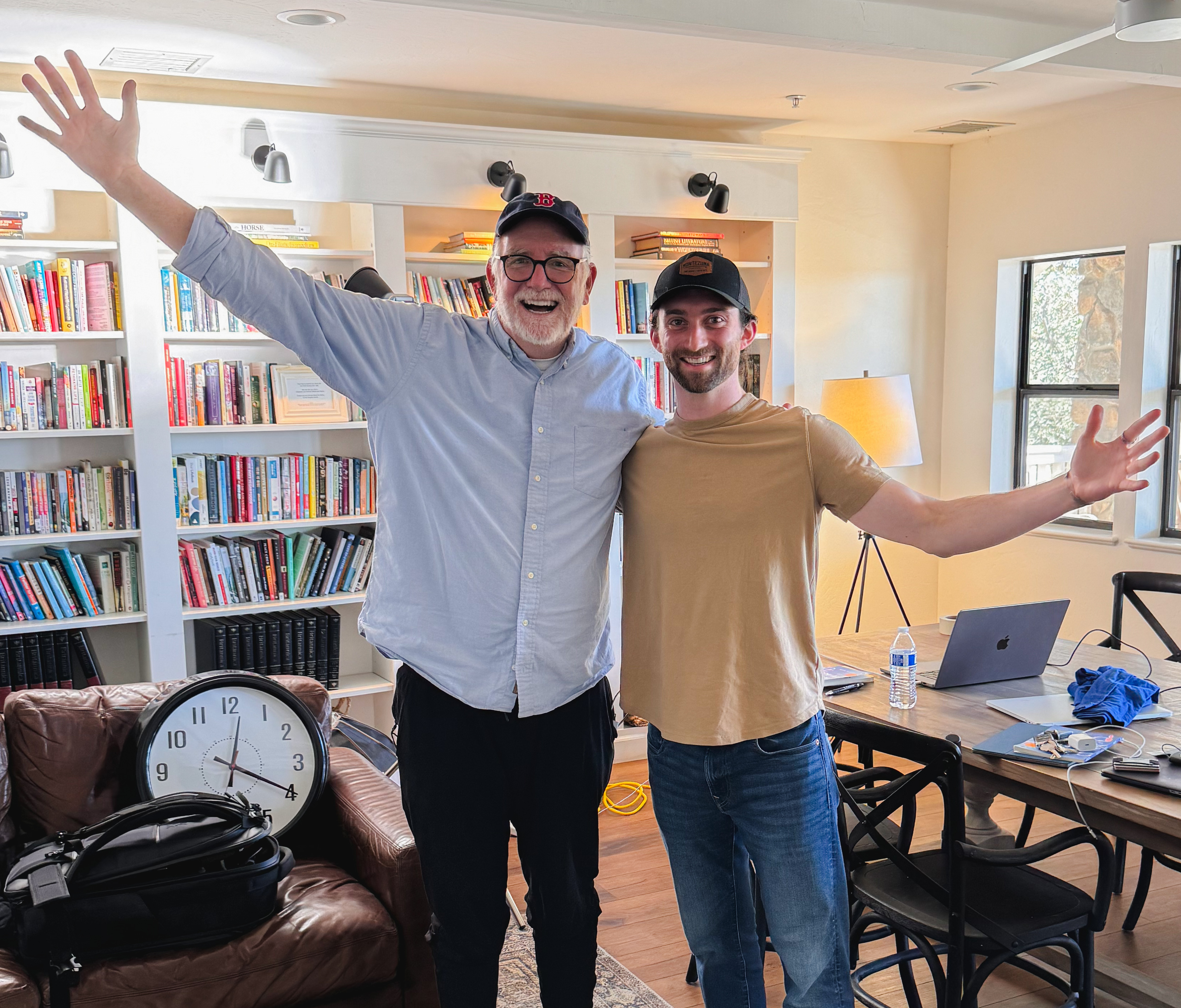 Jake Ward smiles with arms outstretched alongside Bob Goff