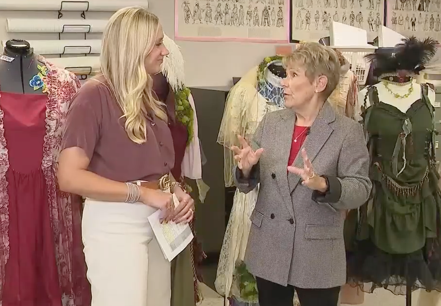 two white females talk in front of mannequins
