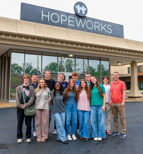 Students posed in front of the Hope Works building.