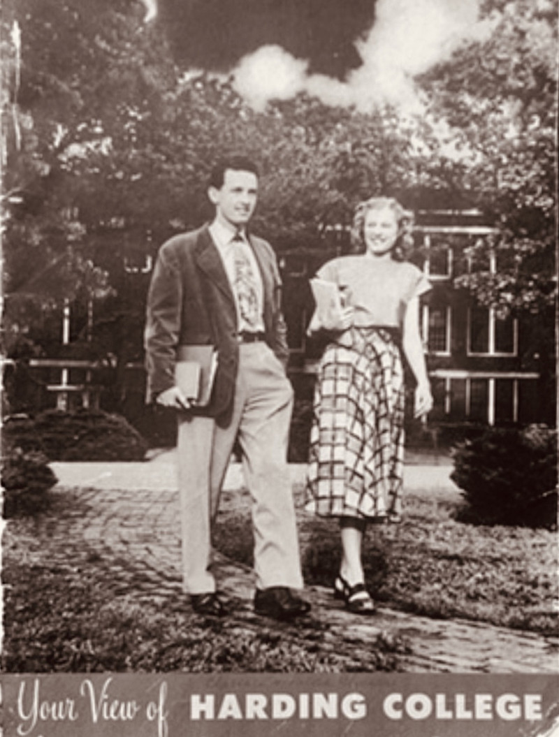 Black and white photo of Clarence and his wife walking on Harding's campus.